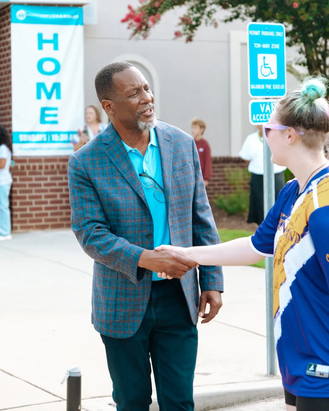 A partnership handshake at an MW Hope Center event