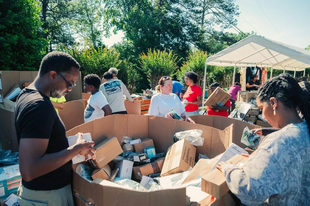 Volunteers sorting donated goods under a tent